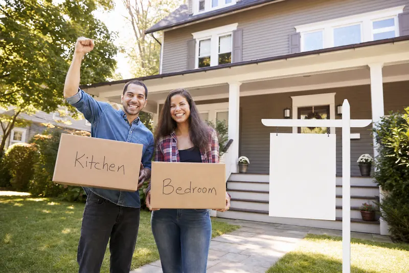 Happy couple celebrating sold home